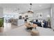 Spacious open-concept living room and kitchen area with modern furnishings and lots of natural light at 7772 Sweet Star Avenue, Orlando, FL 32836