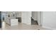 Open floor plan showcasing the kitchen, staircase, and a glimpse of the upstairs living area at 7772 Sweet Star Avenue, Orlando, FL 32836