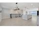 Open-concept space with staircase, kitchen with island and pendant lights, and living area at 7772 Sweet Star Avenue, Orlando, FL 32836