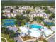 An aerial view of a community with a pool, clubhouse, tennis court, and basketball court surrounded by homes at 8023 King Palm Cir, Kissimmee, FL 34747