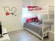 bedroom featuring a playful Mickey Mouse theme, a bunk bed, and durable laminate floors at 8023 King Palm Cir, Kissimmee, FL 34747