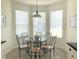 Bright dining area with a round glass table, seating for six, and lots of natural light at 8023 King Palm Cir, Kissimmee, FL 34747