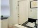 A well-lit laundry room with granite counters, a sink, and a convenient door for outdoor access at 8023 King Palm Cir, Kissimmee, FL 34747