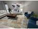 Comfortable living room featuring stylish seating and a modern area rug at 8023 King Palm Cir, Kissimmee, FL 34747