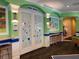 Enter the clubhouse movie theater through whimsical doors with hand-painted art at 8023 King Palm Cir, Kissimmee, FL 34747