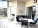 Covered patio space with seating, outdoor bar, and sliding glass doors to the main living area at 8023 King Palm Cir, Kissimmee, FL 34747