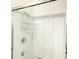 Close-up of a modern shower with sleek glass doors and a chrome showerhead and fixtures at 8023 King Palm Cir, Kissimmee, FL 34747