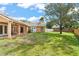 The property features a spacious fenced backyard with a lush green lawn, patio and a large shade tree at 836 Copperfield Ter, Casselberry, FL 32707