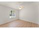 Bright, empty bedroom with hardwood floors and large window at 836 Copperfield Ter, Casselberry, FL 32707