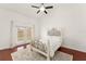 Bedroom with hardwood floors, ceiling fan, and sliding doors to backyard at 836 Copperfield Ter, Casselberry, FL 32707