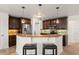 Beautiful kitchen featuring dark wood cabinetry, stainless steel appliances and a breakfast bar at 836 Copperfield Ter, Casselberry, FL 32707