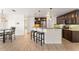 Kitchen with dark wood cabinets, stainless steel appliances, and an island bar with seating at 836 Copperfield Ter, Casselberry, FL 32707
