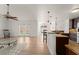 Bright, open living area featuring hardwood floors, high ceilings, and seamless flow into kitchen and dining spaces at 836 Copperfield Ter, Casselberry, FL 32707