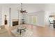 Inviting living room features hardwood floors, a cozy fireplace, and French doors leading to the outdoor space at 836 Copperfield Ter, Casselberry, FL 32707