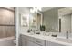 Bright bathroom with double vanity, modern fixtures, and a tiled shower/tub combination at 853 Junonia Blvd, New Smyrna Beach, FL 32168