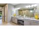 Elegant bathroom with dual vanities, granite countertops, and large mirror at 853 Junonia Blvd, New Smyrna Beach, FL 32168