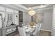 Elegant dining room featuring a chandelier, modern table setting, and neutral color palette at 853 Junonia Blvd, New Smyrna Beach, FL 32168