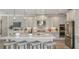 Modern kitchen featuring stainless steel appliances, light gray cabinets, and a central island with seating at 853 Junonia Blvd, New Smyrna Beach, FL 32168