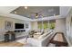 Inviting living room with a large sofa, shuffleboard table, and a view of the backyard at 853 Junonia Blvd, New Smyrna Beach, FL 32168