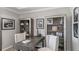 Home office with a desk, two chairs, and built-in bookshelves with decorative items at 853 Junonia Blvd, New Smyrna Beach, FL 32168
