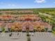 Expansive aerial shot of vibrant townhomes with red roofs and lush landscaping at 8972 Coco Palm Rd, Kissimmee, FL 34747