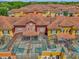 A picturesque aerial view of colorful townhomes with private screened-in pools at 8972 Coco Palm Rd, Kissimmee, FL 34747