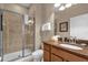 Bathroom with walk in shower, wood vanity and granite countertop at 8972 Coco Palm Rd, Kissimmee, FL 34747