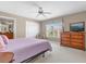 Bedroom featuring carpet, a ceiling fan, closet and a large window at 8972 Coco Palm Rd, Kissimmee, FL 34747