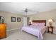 Bedroom featuring carpet, a ceiling fan, closet and a lamps on nightstands at 8972 Coco Palm Rd, Kissimmee, FL 34747