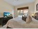 Bedroom with window, ceiling fan, neutral carpet and a dark wood dresser at 8972 Coco Palm Rd, Kissimmee, FL 34747