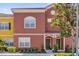 Charming multi-Gathering home with red facade and well-maintained landscaping at 8972 Coco Palm Rd, Kissimmee, FL 34747
