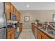 Well-equipped kitchen with stainless steel appliances, granite countertops and wood cabinets at 8972 Coco Palm Rd, Kissimmee, FL 34747