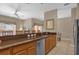 Kitchen featuring granite counters, stainless steel appliances, wood cabinets and a breakfast bar at 8972 Coco Palm Rd, Kissimmee, FL 34747