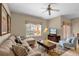 Inviting living room with comfortable seating, natural light, and a ceiling fan at 8972 Coco Palm Rd, Kissimmee, FL 34747