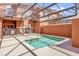 Outdoor pool offers a refreshing retreat with a screened enclosure and ample seating at 8972 Coco Palm Rd, Kissimmee, FL 34747