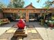 Unique backyard with beautiful statue water feature and custom decorative fish art on the house at 913 Red Fox Rd, Altamonte Springs, FL 32714