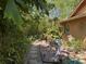 A stone paver path leads through a verdant backyard, a tranquil escape into nature's embrace at 913 Red Fox Rd, Altamonte Springs, FL 32714