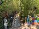 A stone paver path leads through a serene backyard surrounded by lush greenery, creating a peaceful retreat at 913 Red Fox Rd, Altamonte Springs, FL 32714