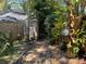 Backyard pathway with lush landscaping is a tranquil escape through natural beauty and charm at 913 Red Fox Rd, Altamonte Springs, FL 32714