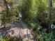 Backyard path featuring stone pavers is a tranquil escape surrounded by lush landscaping and natural beauty at 913 Red Fox Rd, Altamonte Springs, FL 32714