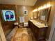 Bathroom view highlighting tiled shower, double sink vanity, and stained glass window at 913 Red Fox Rd, Altamonte Springs, FL 32714