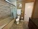 Cozy bathroom featuring a shower over tub with glass doors, tile surround, and marble-look vanity at 913 Red Fox Rd, Altamonte Springs, FL 32714