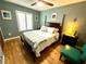Bedroom featuring hardwood floors, ceiling fan, and a comfortable queen-sized bed at 913 Red Fox Rd, Altamonte Springs, FL 32714