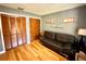 Bedroom featuring hardwood floors, full wall closet, and a sleek black couch at 913 Red Fox Rd, Altamonte Springs, FL 32714