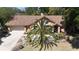 Charming home featuring desert landscaping and a well-manicured yard with a fresh brown roof and mature palm tree at 913 Red Fox Rd, Altamonte Springs, FL 32714
