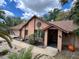 Inviting home with desert landscaping, featuring a fresh brown roof, artful sun decor, and charming front entry at 913 Red Fox Rd, Altamonte Springs, FL 32714
