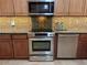 Well-equipped kitchen featuring stainless steel appliances, granite countertops, and ample cabinet space for storage at 913 Red Fox Rd, Altamonte Springs, FL 32714