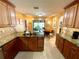 Well-lit kitchen boasting wooden cabinets, granite countertops, mosaic backsplash, and an open layout to the dining area at 913 Red Fox Rd, Altamonte Springs, FL 32714