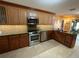 Well-lit kitchen featuring custom cabinetry, stainless steel appliances, and sleek countertops at 913 Red Fox Rd, Altamonte Springs, FL 32714