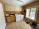 Functional laundry room with a washer, dryer, utility sink, lots of cabinets and a window for natural light at 913 Red Fox Rd, Altamonte Springs, FL 32714